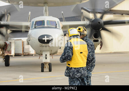 NAVAL AIR FACILITY MISAWA, Japan (March 22, 2011) - Two aviation flight handlers assist an E-2 Hawkeye park on the Navy ramp at Naval Air Facility Misawa (NAFM). The aircraft are attached to Carrier Airborne Early Warning Squadron 113 and are deployed aboard USS Ronald Regan (CNV 76). The airplanes are in Misawa to support Operation Tomodachi.  (U.S. Navy photo by Mass Communication Specialist 1st Class Jose Lopez, Jr./ released) 110322-N-VA590-095 by Commander, U.S. Naval Forces Japan (CNFJ) Stock Photo