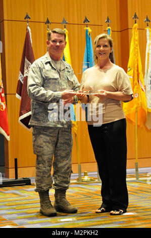 In this image released by the Texas Military Forces, Texas Adjutant General Maj. Gen. John Nichols presents State Family Program volunteer awards during the National Guard Association of Texas Joint Military Affairs Conference opening ceremony in Corpus Christi Friday, March 25, 2011. Volunteers work with state family programs to support Soldiers, Airmen and their families at home and during deployments. The Tag presented the awards in appreciationg and recognition of the volunteers' dedication to servicemembers and their families. TAG presents awards by Texas Military Department Stock Photo