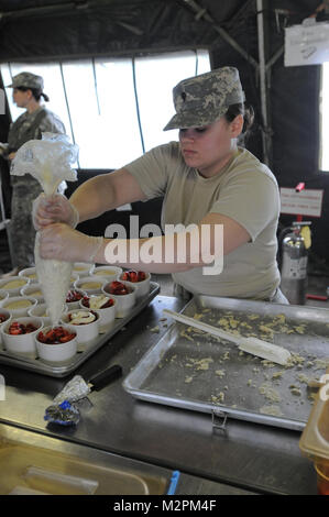 Spc. Isis Salgado of the 452nd Combat Support Hospital assembles strawberry shortcake at the U.S. Army Reserve's Connelly Competition at Fort McCoy, Wis., on April 9.  (Photo by Maj. Matt Lawrence, 807th MDSC Public Affairs). 20110409-DSC 2948 by 807MCDS Stock Photo