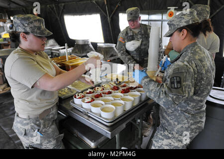 Spc. Jessica Botello-Mora and Spc. Isis Salgado of the 452nd Combat Support Hospital assemble strawberry shortcake at the U.S. Army Reserve's Connelly Competition at Fort McCoy, Wis., on April 9.  (Photo by Maj. Matt Lawrence, 807th MDSC Public Affairs). 20110409-DSC 2959 by 807MCDS Stock Photo