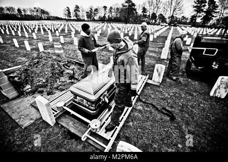 CALVERTON, N.Y. -- Calverton National Cemetery employees and guests conducts a special ceremony for veterans who had no one attend their funeral, April 13. On the second Wednesday of each month the cemetery organizes a color guard and a flag-folding detail to give proper honors to these deceased service members who were buried without friends or family at their own ceremony. Michael Picerno, Calverton National Cemetery director, estimates that 300-400 veterans are buried each year without friends or family at their service. (Official Marine Corps photo by Sgt. Randall Clinton / RELEASED) Natio Stock Photo