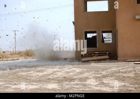 Engineers with C Company, Special Troops Battalion, 2nd Brigade, 1st Infantry Division, United States Division – Center detonate a silhouette charge to breach a door during training at a range at Camp Taji, Iraq, April 20, 2011. The Soldiers spent the day running through the scenario multiple times as dry fire and live fire exercises, implementing different charges each time. (U.S. Army photo by Spc. William K. Ermatinger, 2nd AAB, 1st Inf. Div., USD-C) Dry fire and live fire exercises, by United States Forces - Iraq (Inactive) Stock Photo