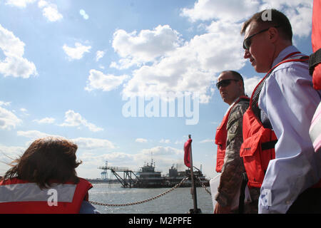 Col. Andy Backus, Norfolk District commander and Mike Darrow, the district's water resources division chief, look out at the dredge working to deepen the Elizabeth River for aircraft carriers. The three were aboard the Work Vessel Harrell touring some of Norfolk District's ongoing projects.  (U.S. Army photo/Kerry Solan) 110430-A-ET072-036 by norfolkdistrict Stock Photo