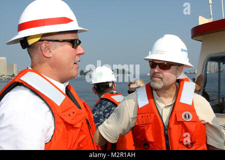 Mike Darrow, chief of water resources division for the Norfolk District (left), talks with Patrick McCormack, from Naval Facilities Command Mid-Atlantic , about the Navy Deepening project, which Norfolk District is assisting with to deepen the Elizabeth River to 50 feet. The project will make the channel safer for the U.S. Navy’s aircraft carriers as they travel between the Norfolk Naval Shipyard in Portsmouth, Va., and the Norfolk Naval Station in Norfolk, Va. (U.S. Army photo/Patrick Bloodgood) 110722-A-OI229-016 by norfolkdistrict Stock Photo