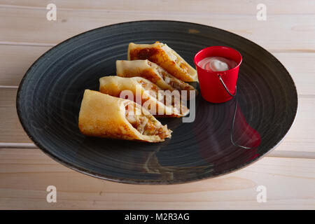 Thin pancakes with ham, bacon and barbecue sauce Stock Photo