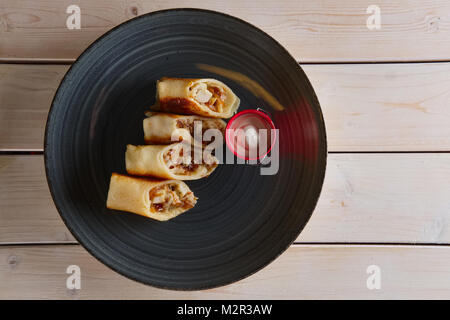 Thin pancakes with ham, bacon and barbecue sauce Stock Photo