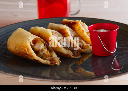 Thin pancakes with ham, bacon and barbecue sauce Stock Photo