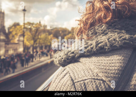 A woman sits in an open sightseeing bus in London - England, Great Britain Stock Photo