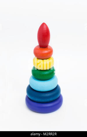 Children's wooden multi-colored pyramid on a white background. A toy for small children Stock Photo