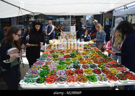 colourful fridge magnets shaped like flowers and fruit on a brooklyn street stall new york park slope Stock Photo