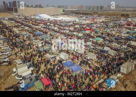 Shenyang. 8th Feb, 2018. Aerial photo taken on Feb. 8, 2018 shows people shopping Spring Festival goods at a grand fair in Yingkou City of northeast China's Liaoning Province, on the day of Xiaonian (small year). Xiaonian falls on the 23rd or 24th day of the last month of the Chinese traditional lunar calendar, marking the start of the countdown to Spring Festival. Credit: Pan Yulong/Xinhua/Alamy Live News Stock Photo