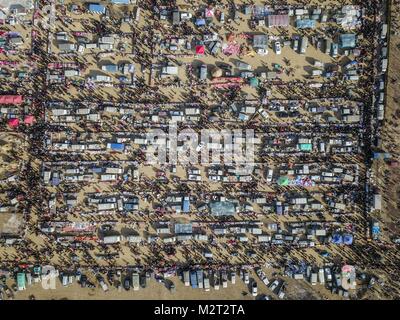 Shenyang. 8th Feb, 2018. Aerial photo taken on Feb. 8, 2018 shows people shopping Spring Festival goods at a grand fair in Yingkou City of northeast China's Liaoning Province, on the day of Xiaonian (small year). Xiaonian falls on the 23rd or 24th day of the last month of the Chinese traditional lunar calendar, marking the start of the countdown to Spring Festival. Credit: Pan Yulong/Xinhua/Alamy Live News Stock Photo