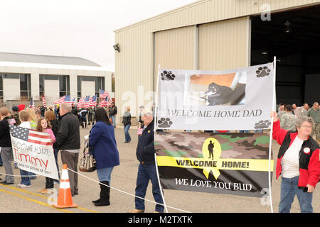 BATON ROUGE, La. – Family and friends of approximately 70 Soldiers from the 239th Military Police Company wave signs and flags to greet them as they return home at the Baton Rouge Metropolitan Airport  in Baton Rouge, La., Dec. 17, 2011. The company was deployed to Iraq in support of Operation New Dawn to conduct law enforcement operations and Police Transition Training for Iraqi law enforcement officers throughout Iraq. (U.S. Air Force Photo by Master Sgt. Toby M. Valadie, Louisiana National Guard Public Affairs Office/Released) 239th MP Co returns home from Iraq 111217-F-VU198-002 by Louisia Stock Photo