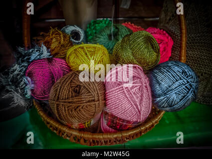 Multicolored balls of yarn in a basket Stock Photo