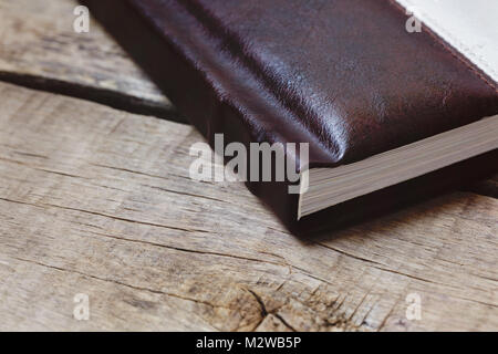Photo album, photobook memories on a wooden table. Stock Photo