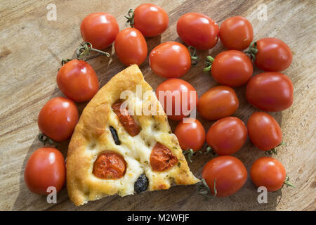 wedge of flatbread or focaccia with cherry tomatoes Stock Photo