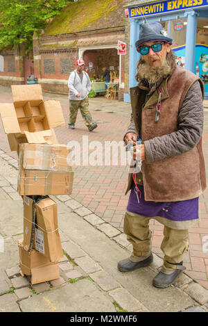 Quirky male character with his home made cardboard sculpture in Canterbury High Street, Kent, UK. Stock Photo