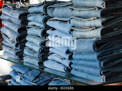 Closeup shot of stack of folded jeans in the fashion store Stock Photo