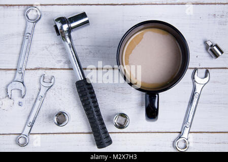 Coffee cup and equipment repair on the white wooden background. Stock Photo