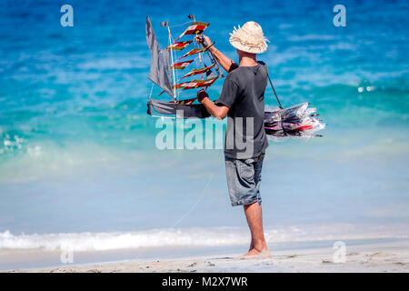 Bali, August 31, 2013: Balinese boy sells kites on the Bali beach Stock Photo