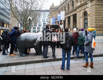 tourist crowd gathering around the bull and bear sculpture in front of historic Frankfurt Stock Exchange building Stock Photo