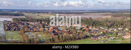 Aerial landscape photo, panoramic view of a small village between fields and meadows, as banner for a blog or website, drone shot Stock Photo