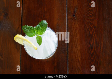 Glass of fresh lemonade with leaves of lemon balm, slice of lemon and ice Stock Photo