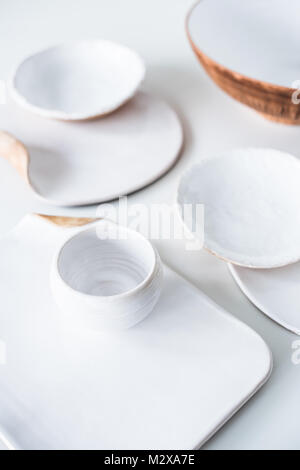 Set of beautiful handmade ceramic, various handcrafted plates and dishes on white background Stock Photo