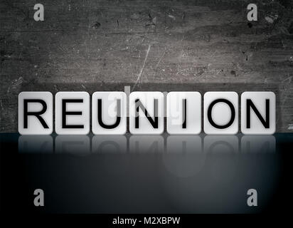 The word Reunion concept and theme written in white tiles on a dark background. Stock Photo