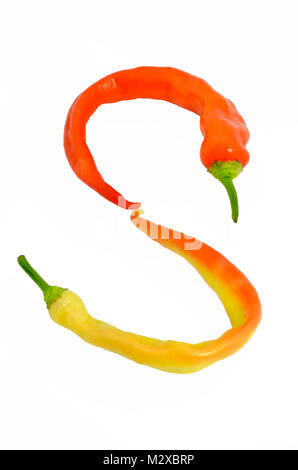 Orange and yellow chili peppers on a “s” figure Stock Photo