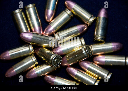 A cluster of shiny 9mm Luger ammunition. Stock Photo