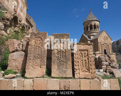 Noravank Monastery in southern Armenia Surb Astvatsatsin church behind three old cross-stones, khachkars Stock Photo