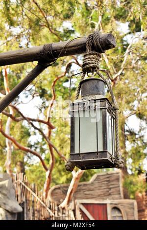 Old Antique lantern hanging on a post In Disneyland California Stock Photo