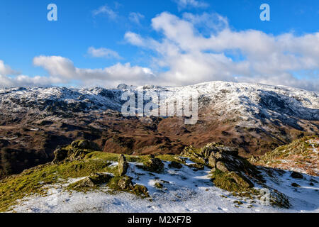 Looking across to Easedale Tarn and the Langdales from the summit of Helm Crag on a cold winter's day Stock Photo