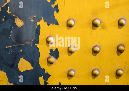clinched metal plate background - vintage industrial background, yellow Stock Photo