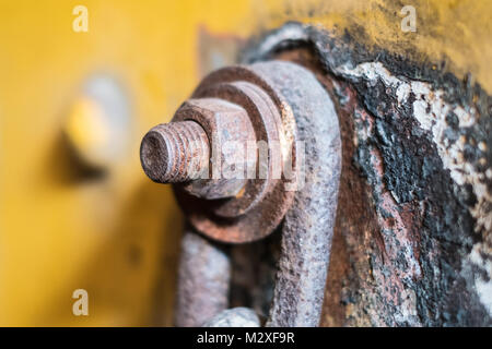 rusty srew and nut closeup connected with rusted chain Stock Photo