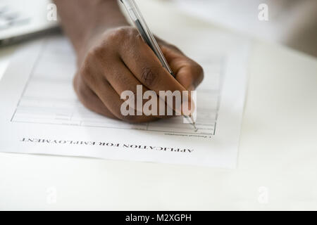 African american man filling employment application, black jobless person applicant writing personal information in form apply for new job, unemployme Stock Photo