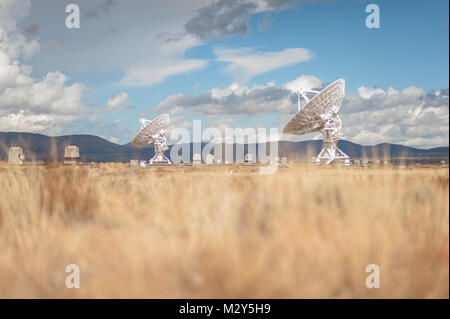 Very Large Array (VLA) Radio Telescopes with nature in the foreground located at the National Radio Astronomy Observatory Site in Socorro, New Mexico. Stock Photo