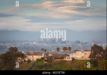 View of Downtown L.A with houses in the foreground photographed at sunset from the top of the Kenneth Hahn State Recreation Area in Los Angeles, CA. Stock Photo