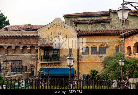 Rustic Tuscany Style buildings with terracotta roofs, vintage style street lamps & picket fence. Arched windows & blue awning in bottom centre. Stock Photo