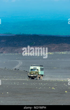 Russian truck drives through the lava sand field of the  Tolbachik volcano, Kamchatka, Russia Stock Photo