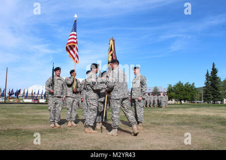 Col. Brian Reed, Commander of the 1st Stryker Brigade Combat Team, 25th Infantry Division, passes the colors of the 3rd Battalion , 21st Infantry Regiment to incoming battalion commander Lt. Col. Scott Schumacher, during a change of command ceremony at Ladd Parade Field, Fort Wainwright, Alaska on July 12, 2012. (U.S. Army photo by Sgt. Michael Blalack, 1/25 SBCT Public Affairs) 120712-A-AX238-010 by 1 Stryker Brigade Combat Team Arctic Wolves Stock Photo