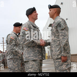 Col. Brian Reed, Commander of the 1st Stryker Brigade Combat Team, 25th Infantry Division, pins the Bronze Star Award with Valor on Sgt. Stephen Stoops, a soldier with the 1st battalion, 24th infantry Regimen, 1/25 SBCT, for heroic actions in Afghanistan in a ceremony on July 23, at Fort Wainwright, Alaska.  (U.S. Army photo by Sgt. Michael Blalack, 1/25 SBCT Public Affairs) 120723-A-AX238-003 by 1 Stryker Brigade Combat Team Arctic Wolves Stock Photo