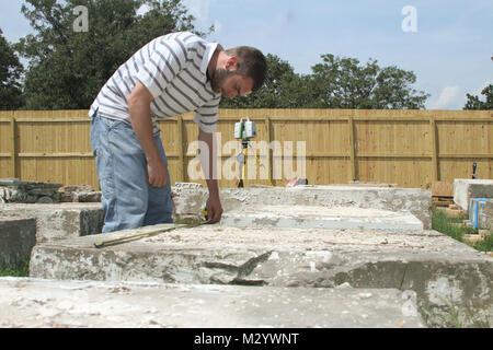 ARLINGTON, Va. -- Ryan Pierce, an architect with the National Park Services’ Historic American Building Survey team, takes detailed measurements on pieces of sandstone columns that once stood at the War Department, August 14, 2012. The columns were moved to Arlington National Cemetery in 1879 and repurposed as gates at the cemetery until 1971 when the cemetery was expanded and the gates were deemed not large enough to allow vehicle traffic through. The gates have been in storage at the cemetery ever since. The cemetery is working with the U.S. Army Corps of Engineers to determine if the column Stock Photo