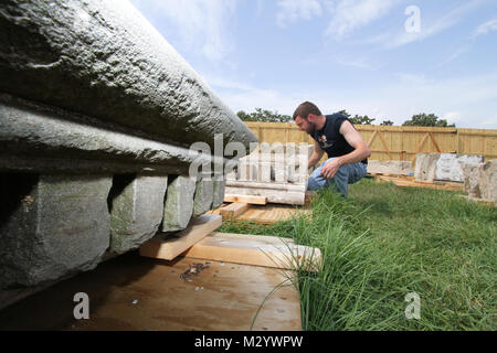 ARLINGTON, Va. -- Ryan Pierce, an architect with the National Park Services’ Historic American Building Survey team, takes detailed measurements on pieces of sandstone columns that once stood at the War Department, August 14, 2012. The columns were moved to Arlington National Cemetery in 1879 and repurposed as gates at the cemetery until 1971 when the cemetery was expanded and the gates were deemed not large enough to allow vehicle traffic through. The gates have been in storage at the cemetery ever since. The cemetery is working with the U.S. Army Corps of Engineers to determine if the column Stock Photo