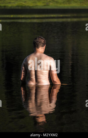 Man bathing in a lake, refreshment in the Alps in summertime, Austria, Europe Stock Photo