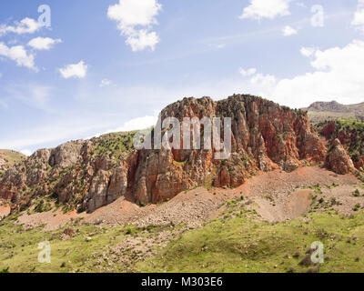 The deep and long Zangezur gorge  with brick red cliffs is leading visitors to the Noravank Monastery in southern Armenia Stock Photo