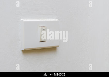 Save electricity Close up of finger is turning on or off on light switch. womans hand with finger on light switch Copy space. Stock Photo