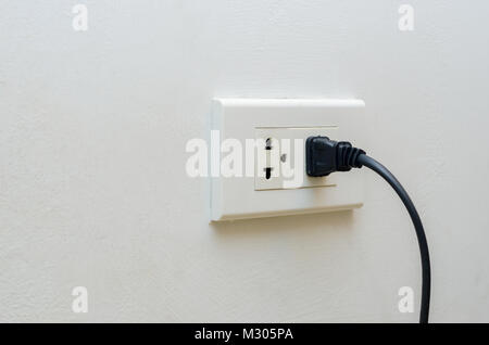 hand outlet Power saving Hand inserting electrical plug into outlet Stock Photo