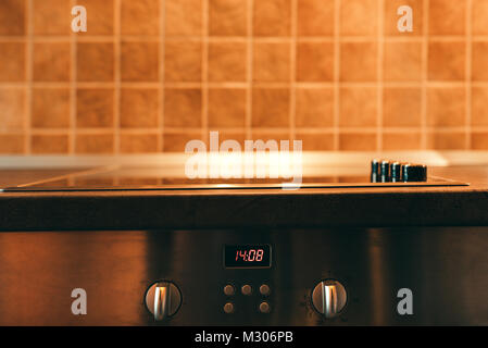 Modern kitchen cooker stove detail close up with selective focus Stock Photo